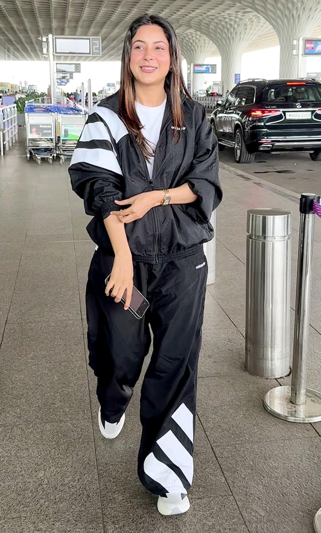 Shehnaaz Gill opted for comfort-meets-style in a black-and-white athleisure tracksuit during her airport appearance.